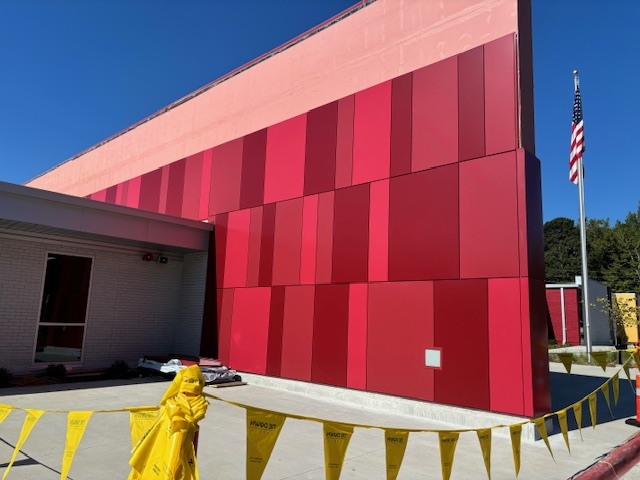 CLADLOK™ panels — red and crimson ACM panels on school building under construction