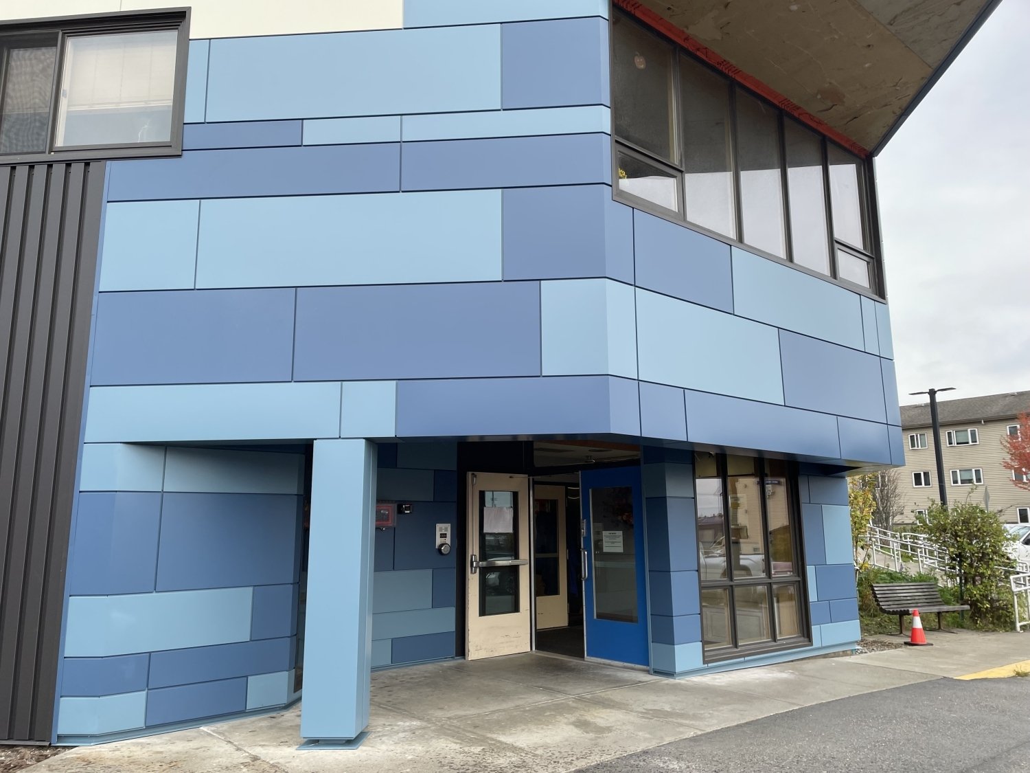 CLADLOK™ panels — blue multi-tone ACM panels on institutional building entrance