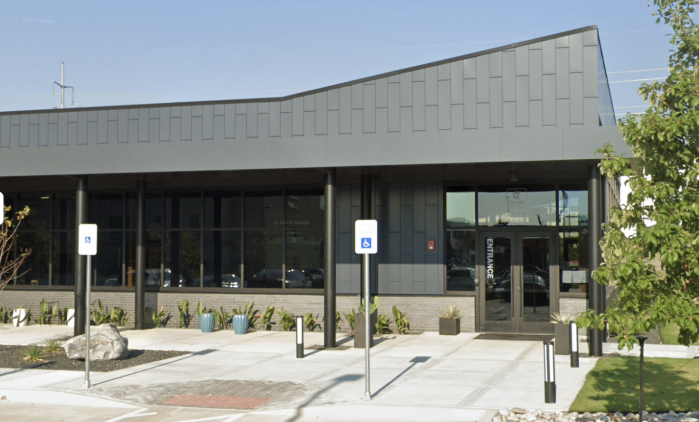 CLADLOK™ panels — dark grey modular cassette panels on commercial building entrance