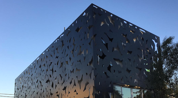 Perforated dark metal facade — ALPOLIC architectural panels